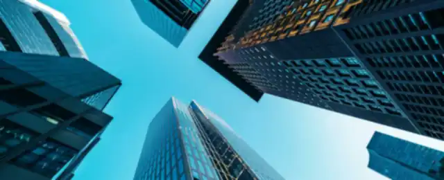Financial district towers seen from below against a clear sky.